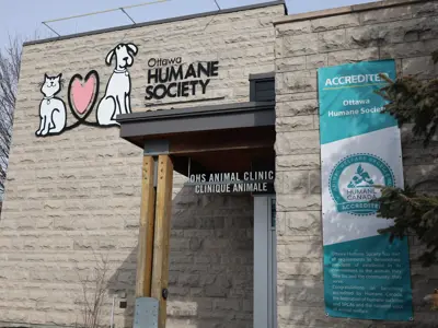 Humane Accreditation Banner on the Ottawa Humane Society building, next to a large OHS logo