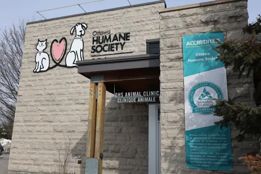 Humane Accreditation Banner on the Ottawa Humane Society building, next to a large OHS logo