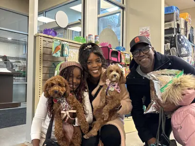 Family posing with their newly adopted dogs. 